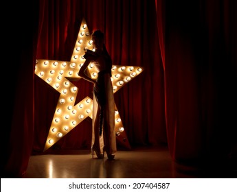  Fashion woman on stage.Red velvet curtain  with brodway star on background 
