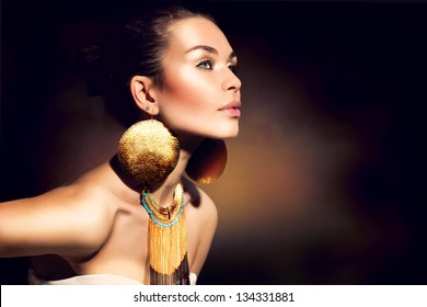 Fashion Woman Portrait. Golden Jewels. Trendy Makeup. Gold Jewellery. Accessories
