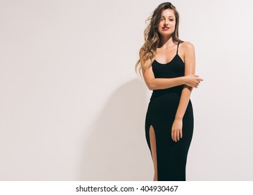 Fashion Woman Portrait Sexy In Black Dress Hot Summer Near White Background 