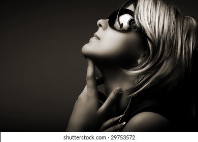 Fashion woman portrait wearing sunglasses on dark background