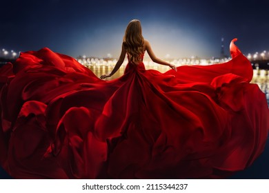Fashion Woman in Red fluttering Dress Back Side Rear View. Glamour Model dancing with Long Silk Fabric flying on Wind over Night Sky City Light Landscape - Shutterstock ID 2115344237