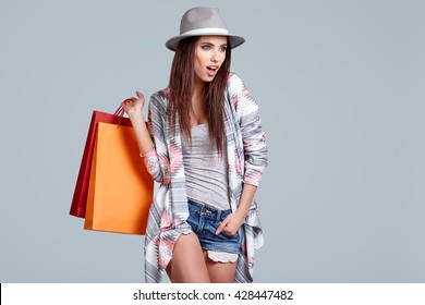 Fashion Woman With Shopping Bags. Studio Shoot