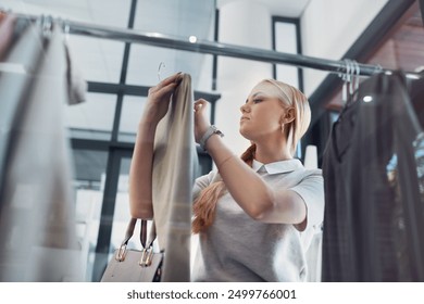 Fashion, woman and shopping in store for clothes, designer and discount or deal with sale in New York. Eco friendly, shop and customer in retail boutique for luxury brand, style and choice on account - Powered by Shutterstock