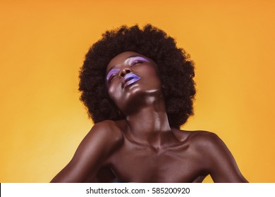 Fashion woman with a short haircut and black skin posing in beauty shot. Shooting, hairstyle,haircut, lips, african american model portrait color colorful closeup water bronze white