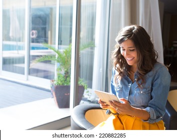 Fashion woman using tablet with sunbeams and lens flare - Powered by Shutterstock