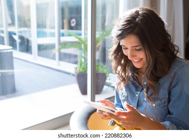 Fashion woman using tablet with sunbeams and lens flare - Powered by Shutterstock