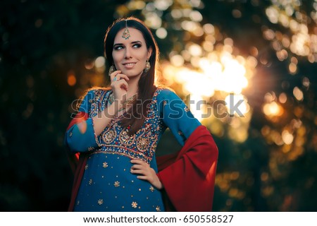 Fashion Woman Wearing Indian Costume and Jewelry Set - Beautiful girl wearing a salwar kameez with matching earrings, mangtika and necklace
