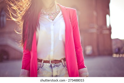 Fashion Women In Pink Blazer With The Sun In The Background