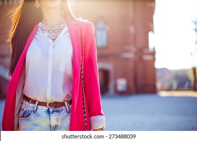 Fashion Women In Pink Blazer With The Sun In The Background