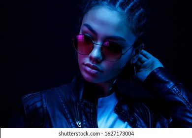 Fashion young african girl woman wear stylish pink glasses looking at camera isolated on black studio background, horizontal banner for website design, portrait, copy space 