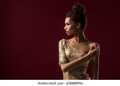 Fashion Young African Woman With Make-up, In Sexy Gold Dress.