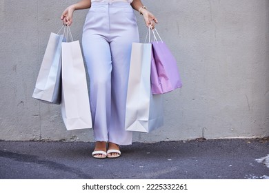 Fashion, zoom shopping bag or woman legs in street road for retail, luxury or designer gift clothes. Leg, model or rich elegant girl for discount, sales or shopping mall for boutique product brand