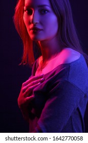 Fashionable Artistic Portrait Of A Beautiful Female Model In Bright Lights. Color Gel Photography