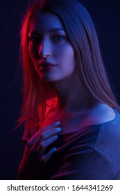 Fashionable Artistic Portrait Of A Beautiful Female Model In Bright Lights. Color Gel Photography