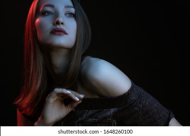 Fashionable Artistic Portrait Of A Beautiful Female Model In Bright Lights. Color Gel Photography