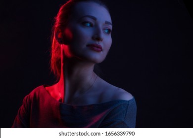 Fashionable Artistic Portrait Of A Beautiful Female Model In Bright Lights. Color Gel Photography