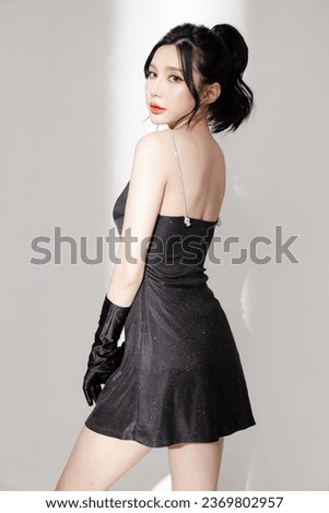 Fashionable Asian woman have good figure and clear fresh skin in black trendy dress pose on isolated white background. Plastic Surgery, Concept of beauty, body and skin care, health, spa, cosmetics.