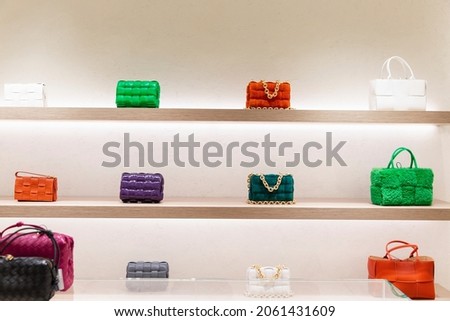 Fashionable bags on the showcase. Elegant, stylish and luxurious accessories. Front view.