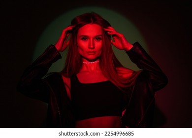 Fashionable beautiful creative woman in colored red light on a dark background with green - Shutterstock ID 2254996685