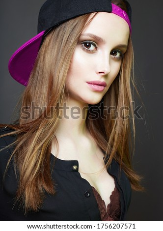 Fashionable beautiful Girl in pink Cap. Teenager style pretty young woman. Healthy Hair