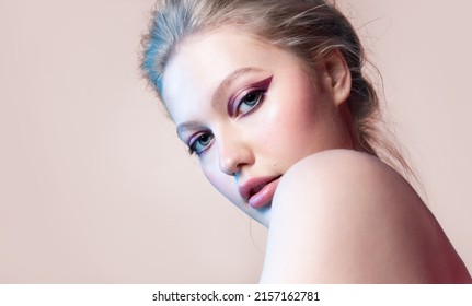 Fashionable Beauty Portrait Of A Girl With  Trendy Creative Makeup With Purple Eyeliner 