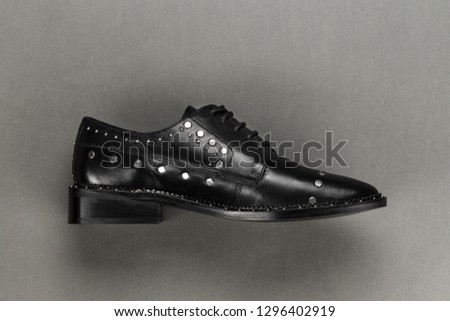 Fashionable black oxfords with rivets. space for text
