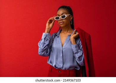 Fashionable Black woman wearing classic satin shirt, trendy sunglasses. Fashion studio portrait. Copy, empty space for text 
 - Shutterstock ID 2149367103