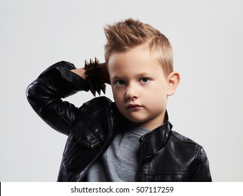 Fashionable child in leather coat.stylish little boy with trendy haircut