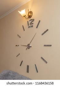 Fashionable Clock Stuck On The Wall In The Room