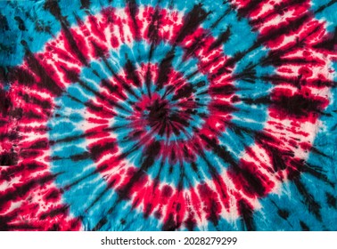 Fashionable Colorful Red, Blue and Black Retro Abstract Psychedelic Tie Dye Swirl Design on cotton shirt. 