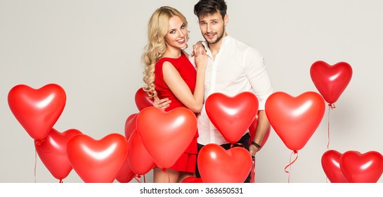 Fashionable Couple With Balloons Heart Hugging At Each Other 