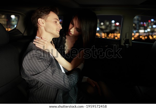 Fashionable couple in love in the car against the\
background of the lights of the big city. Glamorous lifestyle,\
night party.