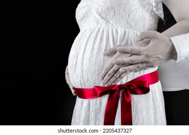 Fashionable Couple Maternity Photo Image With Tied Ribbon Black Background (shooting A Real Pregnant Woman)