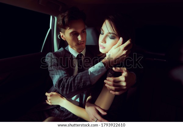 Fashionable couple of young people in the car.\
Glamorous lifestyle, night\
party.