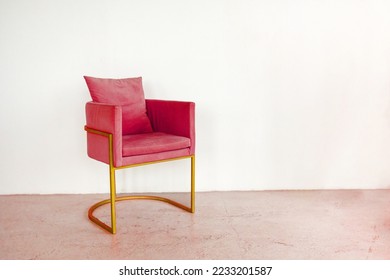 Fashionable designer chair stands against an empty wall. Armchair toning in Viva Magenta color. Trendy creative design of 2023. High quality photo - Shutterstock ID 2233201587