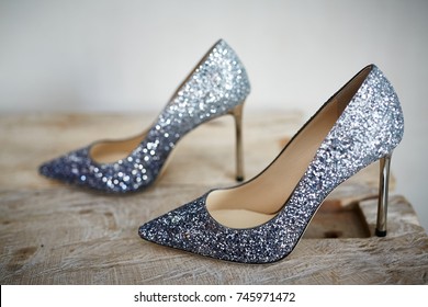 fashionable expensive silver grey high heels on wooden floor 