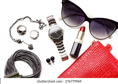 Fashionable female accessories watch sunglasses lipstick and red purse. Overhead of essentials for modern young woman.  - Shutterstock ID 276779969
