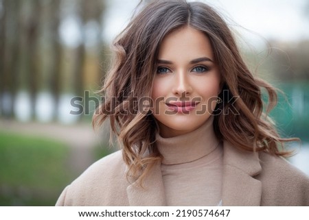 Fashionable female model face. Beautiful brunette outdoor