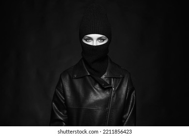 Fashionable Girl In Balaclava And Leather Coat. Trendy Mask On Pretty Woman. Black And White Portrait