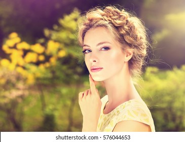 Fashionable Hair Disheveled Braid Around The Head .Happy Beautiful Young Model Girl In Summer Blossom Park.