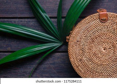Fashionable handmade natural organic rattan bag with clothes and sunglasses.  - Shutterstock ID 1175284111