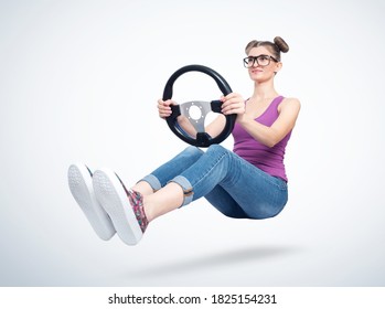 Fashionable Happy Young Woman In Glasses With Car Steering Wheel. Girl Auto Driving Concept