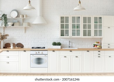 Fashionable Kitchen Interior With Whitewashed Brick Walls, Modern Furniture And Wooden Countertop, No People. Remodelling, Modernizing, Repairs, Renovation Professional Services Advertisement Concept