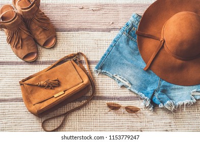 Fashionable lady. Denim shorts, suede bag, stylish sandals, glasses and hat. Top view - Powered by Shutterstock