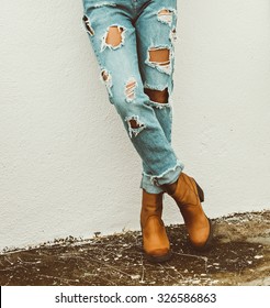 Fashionable Lady Style. Torn Jeans and Boots