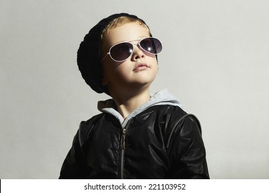 Fashionable Little Boy In Sunglasses. Child.Winter Style.Kids Fashion.Posing Little Model In Black Cap