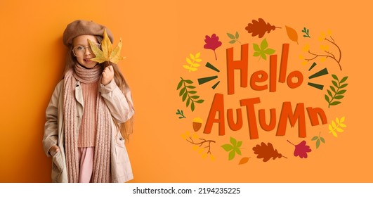 Fashionable little girl in warm clothes on orange background. Hello, autumn
