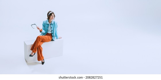 Fashionable look. Portrait of young happy beautiful woman in retro style clothes, vintage outfit, fashion of 50s, 60s isolated on white background. Concept of culture, art, music, fashion style. Flyer - Shutterstock ID 2082827251