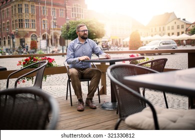Fashionable Man Sitting In Coffee Shop At The Old Town.