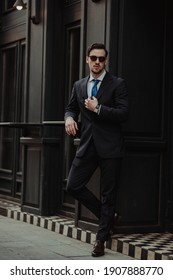 Fashionable man wearing classy suits in the city surrounding - Shutterstock ID 1907888770